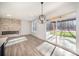 Modern living room featuring a linear fireplace with stone surround and access to outdoor patio through sliding glass doors at 4605 Western Union School Rd, Waxhaw, NC 28173