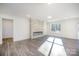 Contemporary living room with sleek fireplace feature, light-filled space, and stylish flooring at 4605 Western Union School Rd, Waxhaw, NC 28173