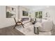 Beautiful living room featuring a stone fireplace, modern furniture, and large windows at 4605 Western Union School Rd, Waxhaw, NC 28173