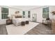 Serene main bedroom with large windows, neutral decor, and a cozy seating area at 4605 Western Union School Rd, Waxhaw, NC 28173