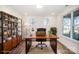 Cozy home office with a large wooden desk, shelving, and natural light from two windows at 4605 Western Union School Rd, Waxhaw, NC 28173