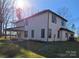 View of rear exterior showcasing light siding, a covered patio with a fire pit, and a well-maintained backyard at 4605 Western Union School Rd, Waxhaw, NC 28173