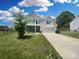Beautiful two-story home with a well-manicured lawn, a two-car garage, and mature trees at 4903 Greenloch Ct, Monroe, NC 28110