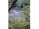 Small creek with rocky bed and green foliage at 499 Indian Hill Rd, Olin, NC 28660