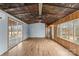 Living room with hardwood floors and rustic tin ceiling at 499 Indian Hill Rd, Olin, NC 28660