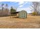 Green storage shed with covered awning, perfect for storing equipment at 499 Indian Hill Rd, Olin, NC 28660