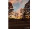 Scenic sunset over a rural landscape with trees at 499 Indian Hill Rd, Olin, NC 28660