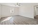 Bright bedroom featuring gray laminate flooring, a ceiling fan, and a window at 505 Kings Mountain St, Clover, SC 29710