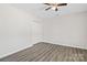 Bedroom featuring gray laminate flooring, closet, ceiling fan, and neutral paint at 505 Kings Mountain St, Clover, SC 29710