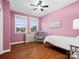 Charming bedroom with hardwood floors and pink walls at 523 Rock Skip Way, Fort Mill, SC 29708