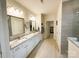 Bathroom featuring dual sinks, granite countertops, and access to a walk-in closet at 577 Rustlewood Way, Rock Hill, SC 29732