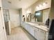 Bright bathroom featuring double sinks, granite counters, and a tiled floor at 577 Rustlewood Way, Rock Hill, SC 29732