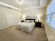 Bright bedroom featuring neutral decor, tray ceiling, and window for natural light at 577 Rustlewood Way, Rock Hill, SC 29732