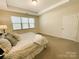 Bright bedroom with neutral tones, large window, and ensuite bathroom at 577 Rustlewood Way, Rock Hill, SC 29732