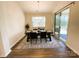 Dining room with modern chandelier, table with seating, and sliding glass doors to patio at 577 Rustlewood Way, Rock Hill, SC 29732