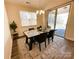 Dining room with modern chandelier, table with seating, and sliding glass doors to patio at 577 Rustlewood Way, Rock Hill, SC 29732