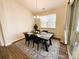 Dining room with modern chandelier, table with seating, and sliding glass doors to patio at 577 Rustlewood Way, Rock Hill, SC 29732