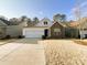 Inviting home featuring a two-car garage, stone details, and lovely landscaping at 577 Rustlewood Way, Rock Hill, SC 29732