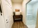 Hallway with storage cabinet and open laundry room with white washer and dryer at 577 Rustlewood Way, Rock Hill, SC 29732