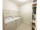 Functional laundry room with white washer and dryer and wire rack shelving for ample storage at 577 Rustlewood Way, Rock Hill, SC 29732