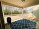 Covered patio with blue patterned rug overlooking a private backyard and trees at 577 Rustlewood Way, Rock Hill, SC 29732