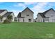 Green grassy backyard with several houses in the background at 5813 Bridgeway Dr, Indian Trail, NC 28079