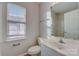 Clean bathroom with single sink vanity, toilet and mirrored medicine cabinet at 5813 Bridgeway Dr, Indian Trail, NC 28079