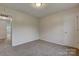 Spacious bedroom with neutral walls, carpet flooring, and a door to hallway at 5813 Bridgeway Dr, Indian Trail, NC 28079