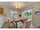 Charming dining room with hardwood floors, a sliding glass door, and a chandelier at 5813 Bridgeway Dr, Indian Trail, NC 28079