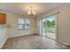 Bright dining room with tile floor, sliding glass door to patio, and chandelier at 5813 Bridgeway Dr, Indian Trail, NC 28079