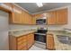 Kitchen features wood cabinets and granite countertops at 5813 Bridgeway Dr, Indian Trail, NC 28079