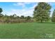 Large lot with lush green grass and mature trees at 5813 Bridgeway Dr, Indian Trail, NC 28079