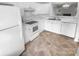 Kitchen with white cabinets, tiled floor and appliances at 609 Mountainwater Dr, Charlotte, NC 28262