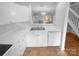 Bright white kitchen features ample cabinetry and a double sink at 609 Mountainwater Dr, Charlotte, NC 28262