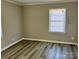 Spacious bedroom with hardwood floors and large window at 624 Windy Hill Dr, Gastonia, NC 28052