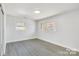 Bright bedroom with wood-look floors and large windows at 6309 Spring Garden Ln, Charlotte, NC 28213