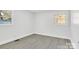 Well-lit bedroom with neutral walls and vinyl flooring at 6309 Spring Garden Ln, Charlotte, NC 28213