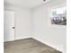 Bright bedroom with neutral walls and wood-look floors at 6309 Spring Garden Ln, Charlotte, NC 28213