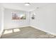 Spacious bedroom with neutral walls and wood-look floors at 6309 Spring Garden Ln, Charlotte, NC 28213