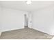 Bright bedroom with neutral walls and wood-look floors at 6309 Spring Garden Ln, Charlotte, NC 28213