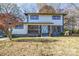 Two-story house with gray and white siding, a light-colored door, and a landscaped yard at 6309 Spring Garden Ln, Charlotte, NC 28213