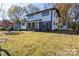 Two-story house with a spacious yard and shed visible in the background at 6309 Spring Garden Ln, Charlotte, NC 28213