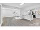 Open concept living room and kitchen with gray vinyl flooring at 6309 Spring Garden Ln, Charlotte, NC 28213