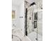 Walk-in shower with marble-look walls and black accents at 6309 Spring Garden Ln, Charlotte, NC 28213