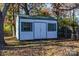 White storage shed with green metal roof at 6309 Spring Garden Ln, Charlotte, NC 28213