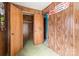 Bedroom with wood paneling, closet, and green carpet at 643 Alf Hoover Rd, Lincolnton, NC 28092