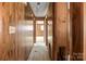 Hallway with wood paneling and access to other rooms at 643 Alf Hoover Rd, Lincolnton, NC 28092