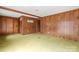 Simple living room with wood paneling and carpeted floors at 643 Alf Hoover Rd, Lincolnton, NC 28092