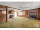 Spacious living room features a brick fireplace and wood paneling at 643 Alf Hoover Rd, Lincolnton, NC 28092