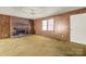 Living room with brick fireplace and wood paneled walls at 643 Alf Hoover Rd, Lincolnton, NC 28092